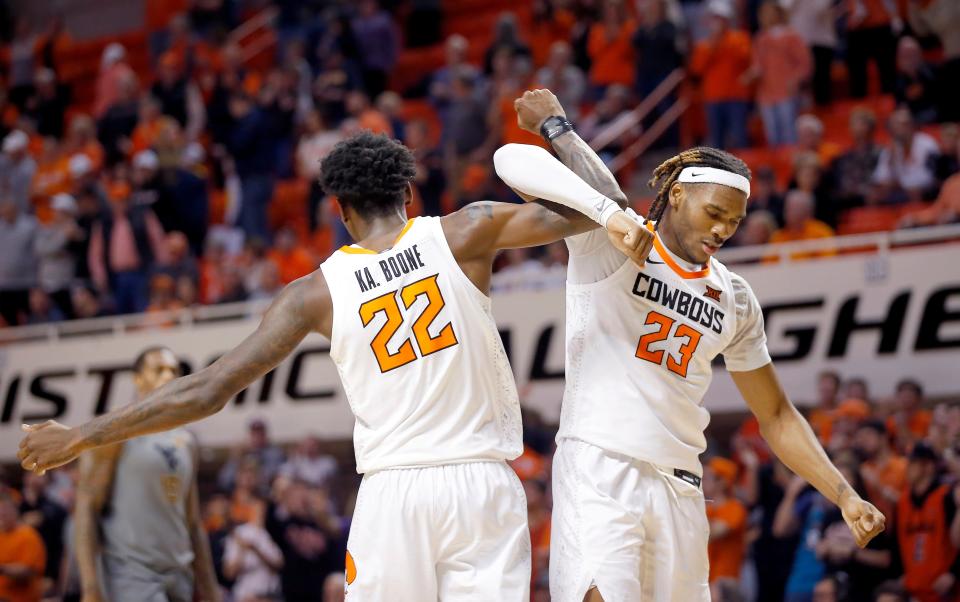 Oklahoma State's Kalib Boone (22) and Tyreek Smith (23) celebrate following the college basketball game between Oklahoma State University Cowboys and the West Virginia Mountaineers at Gallagher-Iba Arena in Stillwater, Okla., Monday, Jan.2, 2023. OSU won 67-60.