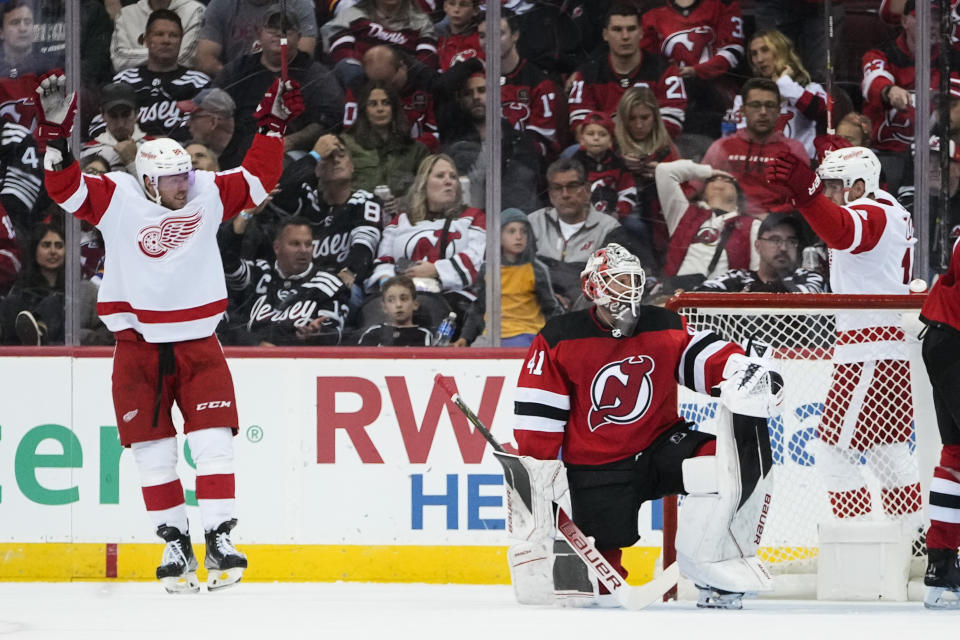 Detroit Red Wings' Daniel Sprong, left, celebrates with Andrew Copp, right, after Sprong scored a goal against New Jersey Devils goaltender Vitek Vanecek (41) during the second period of an NHL hockey game Thursday, Oct. 12, 2023, in Newark, N.J. (AP Photo/Frank Franklin II)