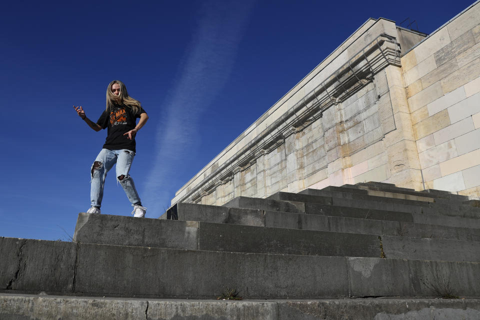 Young citizen of Nuremberg, Christina, practices her hip hop dance performance on the main tribune near the 'Zeppelinfeld' at the 'Reichsparteigelande' (Nazi Party Rally Grounds) in Nuremberg, Germany, Wednesday, Nov. 18, 2020. Germany marks the 75th anniversary of the landmark Nuremberg trials of several Nazi leaders and in what is now seen as the birthplace of a new era of international law on Friday, Nov. 20, 2020. (AP Photo/Matthias Schrader)