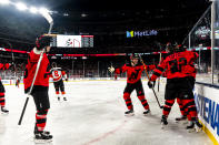 New Jersey Devils players celebrate after Tyler Toffoli, front right, scored against the Philadelphia Flyers in the first period of an NHL Stadium Series hockey game in East Rutherford, N.J., Saturday, Feb. 17, 2024. (AP Photo/Peter K. Afriyie)