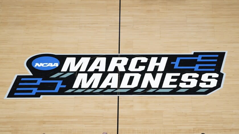 The March Madness logo is shown on the court during the first half of a men's college basketball game.