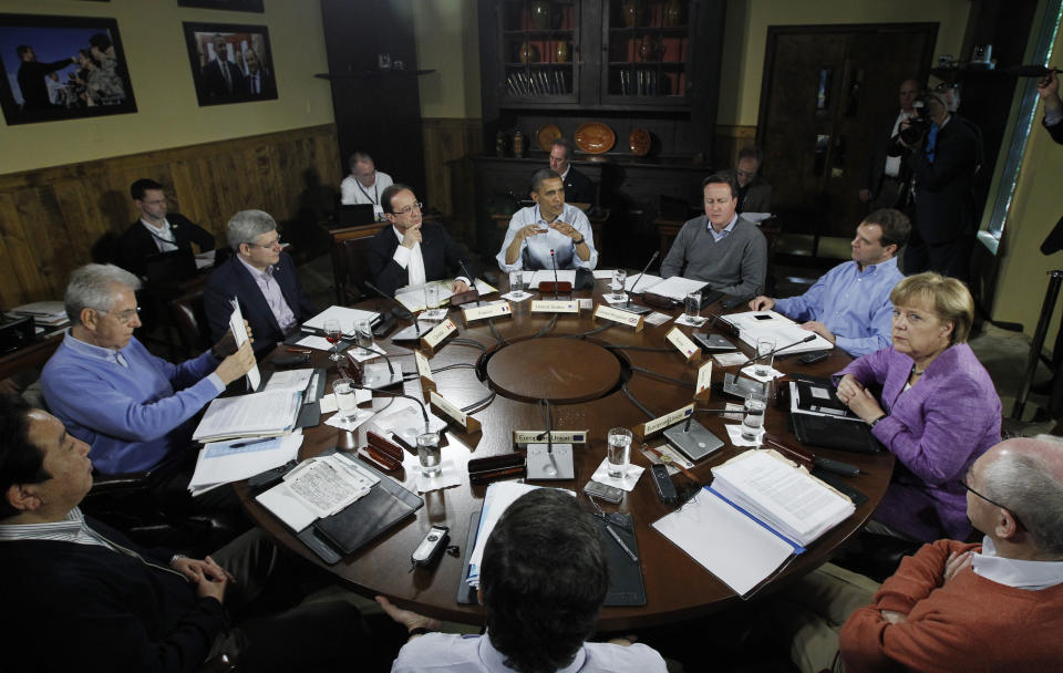 FILE - President Barack Obama, center, leads the first meeting with world leaders at the start of the first session of the G-8 Summit, May 19, 2012, at Camp David, Md. (AP Photo/Charles Dharapak, File)