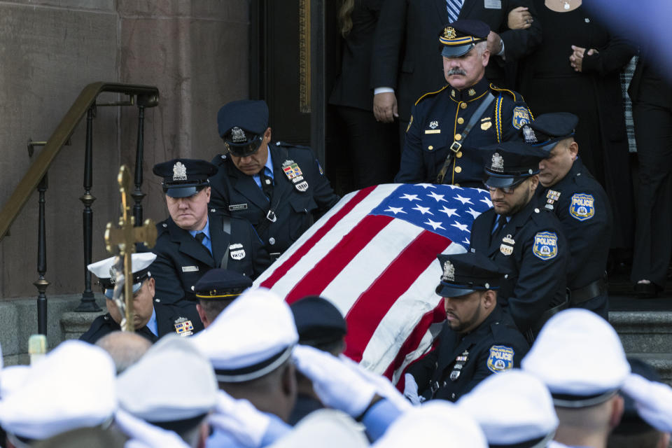 An honor guard carries the casket containing the remains of Philadelphia police officer Richard Mendez from the Cathedral Basilica of Saints Peter and Paul in Philadelphia, Tuesday, Oct. 24, 2023. Mendez was shot and killed, and a second officer was wounded when they confronted people breaking into a car at Philadelphia International Airport, Oct. 12, police said.