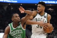 Milwaukee Bucks' Giannis Antetokounmpo drives past Boston Celtics' Aaron Nesmith during the first half of an NBA basketball game Thursday, April 7, 2022, in Milwaukee. (AP Photo/Morry Gash)