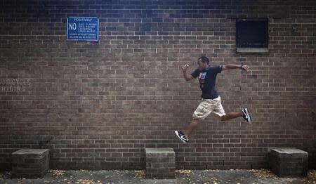 Rashaad Gomez practises parkour in a park in New York October 7, 2013. REUTERS/Carlo Allegri