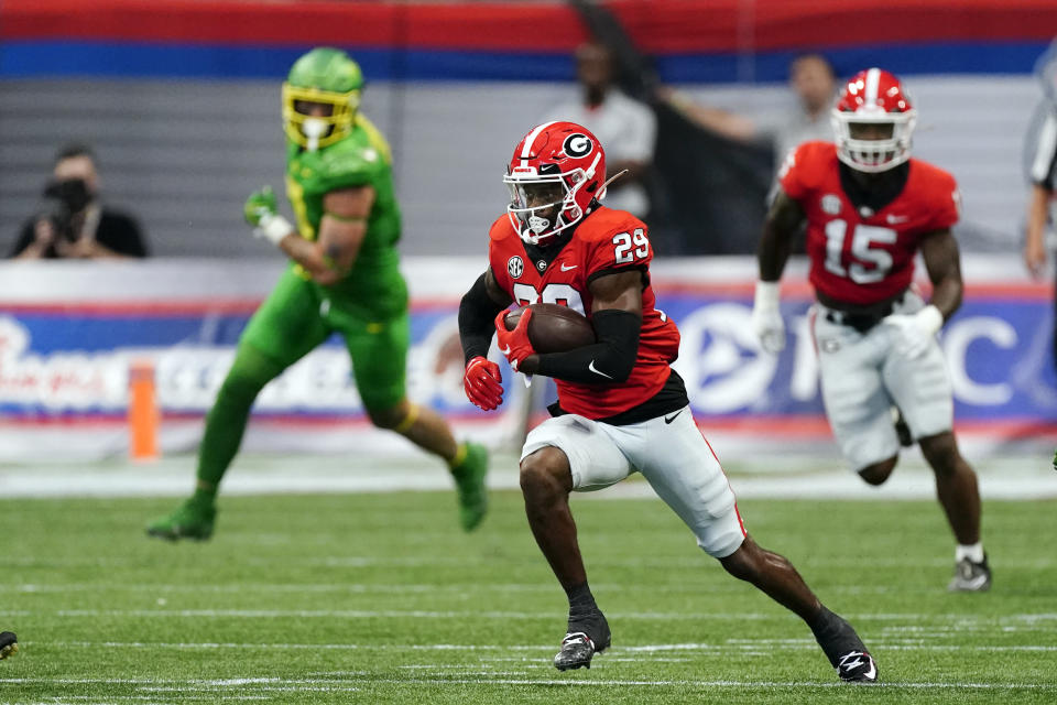 Georgia defensive back Christopher Smith (29) runs the ball after an interception in the first half of an NCAA college football game against Oregon, Saturday, Sept. 3, 2022, in Atlanta. (AP Photo/John Bazemore)