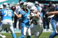 Carolina Panthers quarterback Bryce Young (9) aims a pass under pressure from Miami Dolphins linebacker Andrew Van Ginkel (43) during the first half of an NFL football game, Sunday, Oct. 15, 2023, in Miami Gardens, Fla. (AP Photo/Wilfredo Lee)
