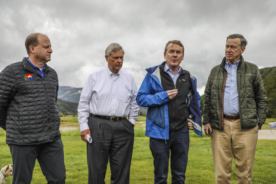 FILE - From left, Colorado Governor Jared Polis, United States Department of Agriculture Secretary Thomas Vilsack, Sen. Michael Bennet D-Colo. and Sen. John Hickenlooper, D-Colo. talk to the media about the CORE Act Tuesday, Aug. 16, 2022 at Camp Hale, Colo. Top Colorado Democrats are asking President Joe Biden to declare a new national monument in the heart of the state's Rocky Mountains. The monument would be called Camp Hale - Continental Divide National Monument. (Chris Dillmann/Vail Daily via AP)