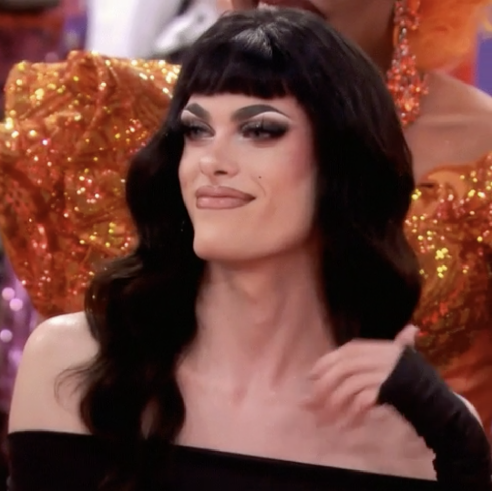 Close-up of a contestant on "RuPaul's Drag Race" smiling slightly