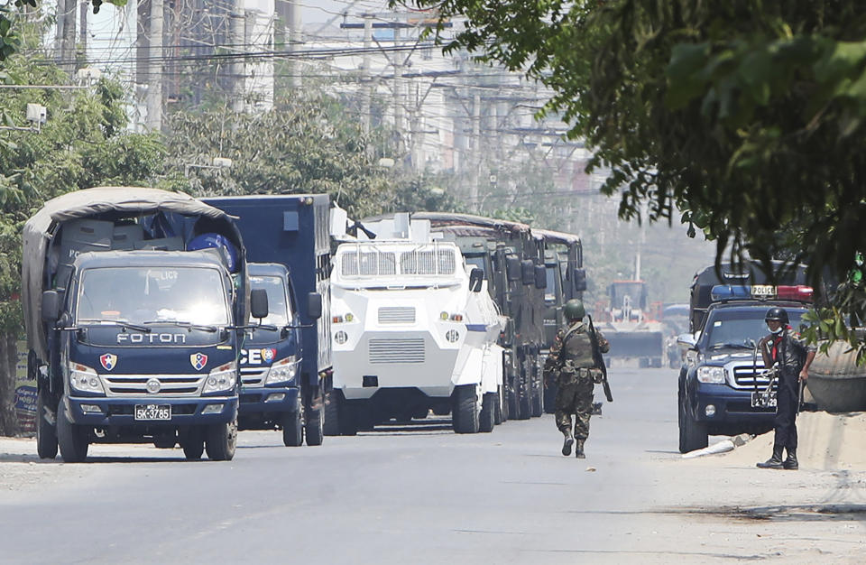 A soldier walks along a row of vehicles by security forces parked on a road in Mandalay, Myanmar Friday, March 19, 2021. The authorities in Myanmar have arrested a spokesman for ousted leader Aung San Suu Kyi's political party as efforts to restrict information about protests against last month's military takeover are tightened. (AP Photos)