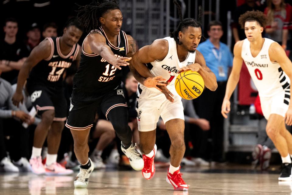 Cincinnati Bearcats forward Day Day Thomas (1) steals the ball from Oklahoma State Cowboys guard Javon Small (12) Wednesday. Thomas scored 10 points, but Small had 19 in the Cowboys 80-76 win.