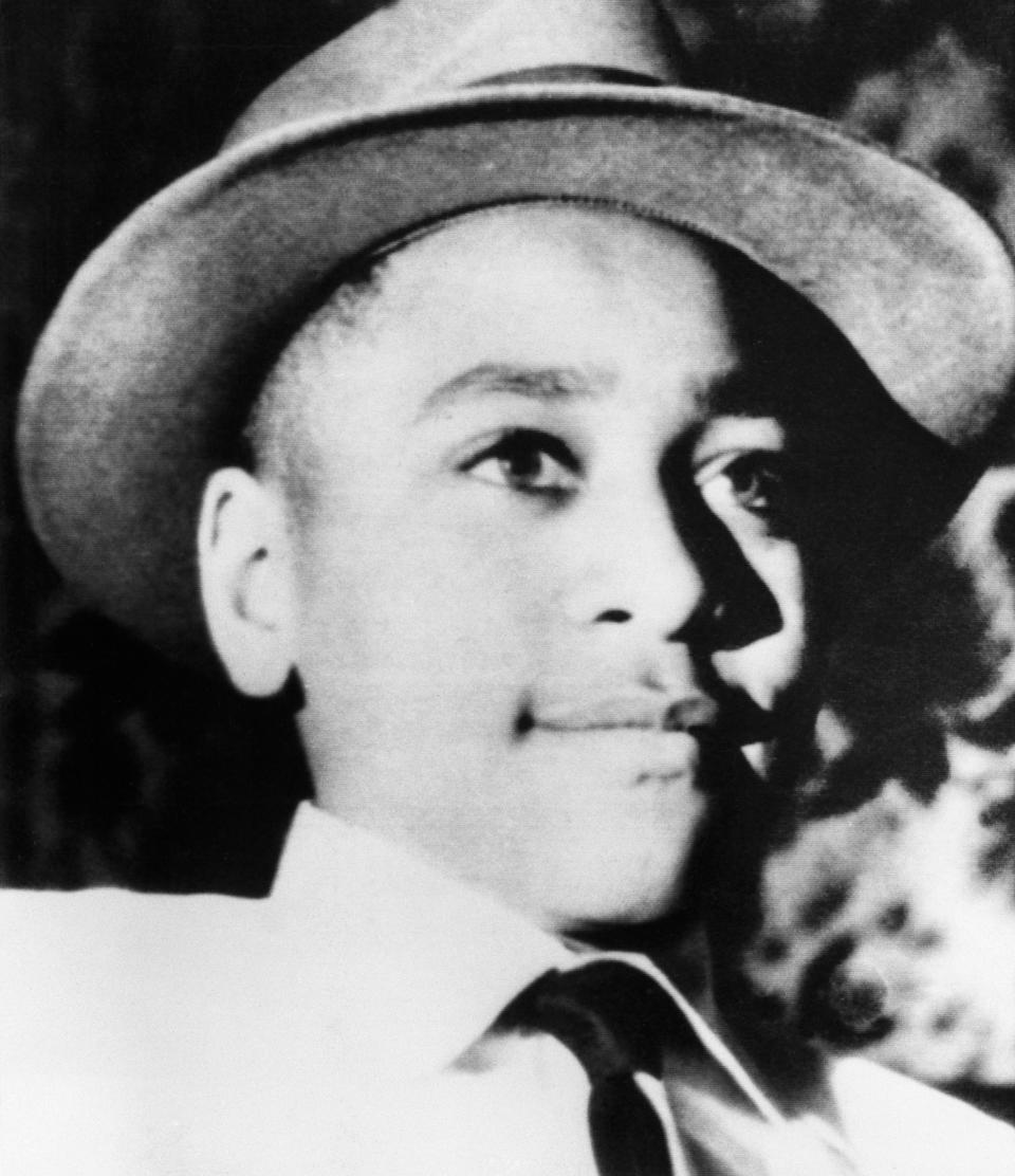 Emmett Till, 14, wearing a hat and smiling in black and white photo. 