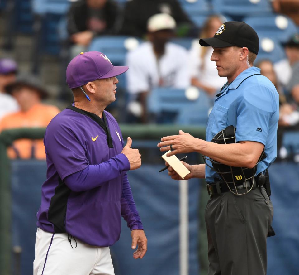 LSU head coach Ethan Petry talks with the home plate umpire during the second round of the SEC Baseball Tournament at the Hoover Met Wednesday, May 24, 2023.