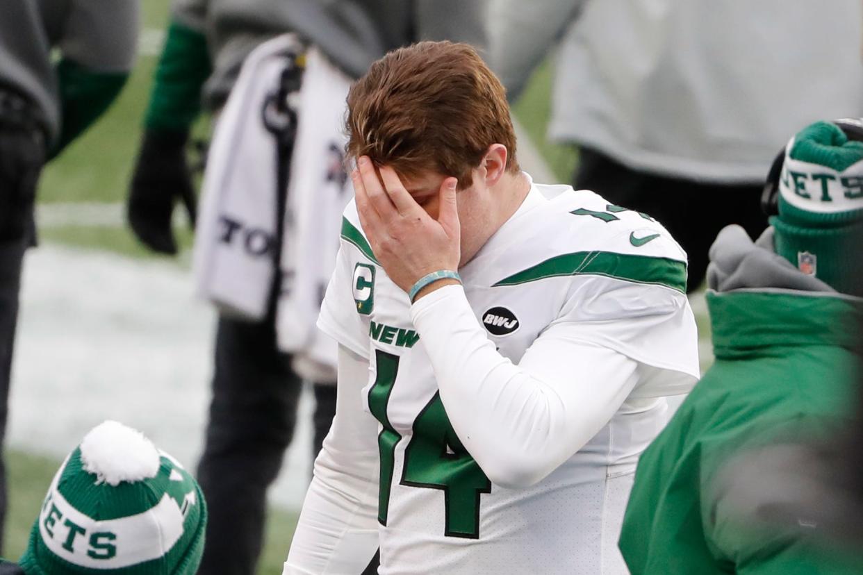 New York Jets quarterback Sam Darnold (14) heads to the bench during the first half against the New England Patriots at Gillette Stadium.