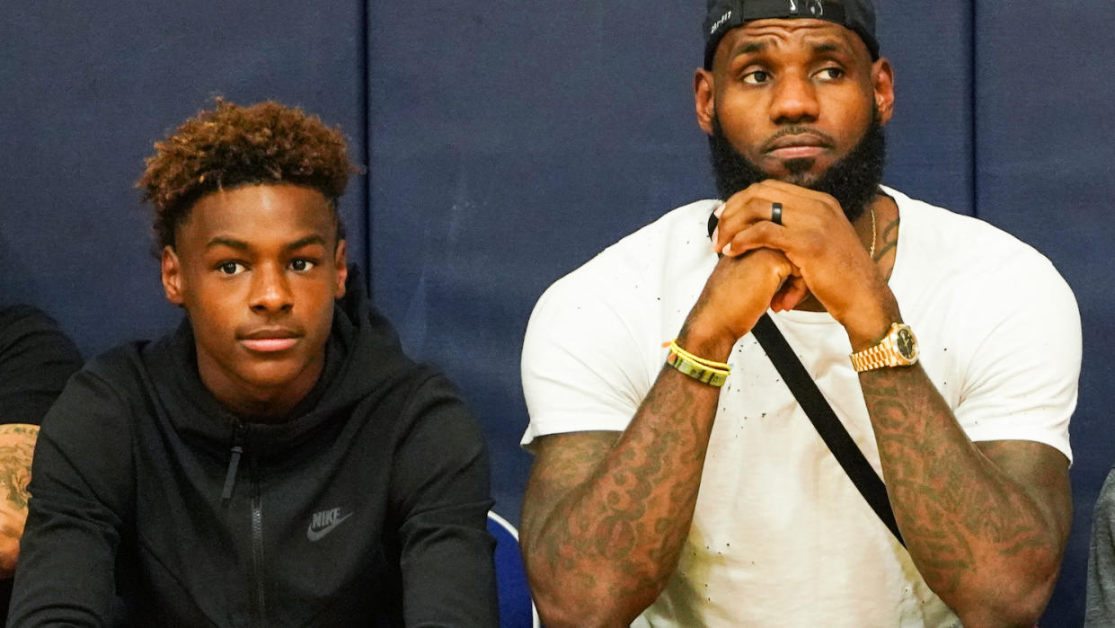 LeBron James Jr. and his father watch an AAU game together this summer. (Getty Images)