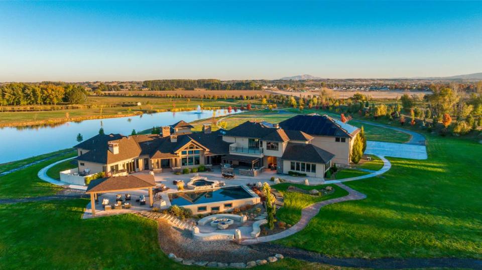The $6.2 million home Brett Hughes sold sits near the Boise River and includes multiple fire pits, an outdoor area for hosting and a cooking-area.