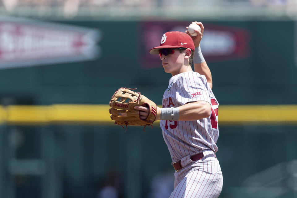 Oklahoma infielder Jackson Nicklaus (15) throws out Texas A&M infielder Jack Moss in the first inning during an NCAA College World Series baseball game Friday, June 17, 2022, in Omaha, Neb. (AP Photo/John Peterson)