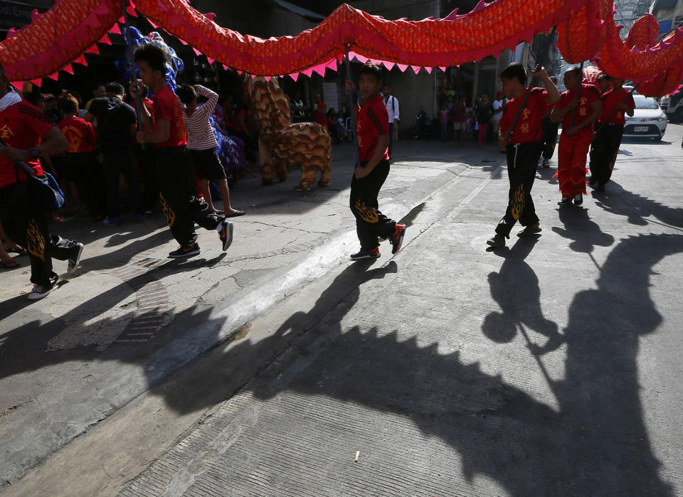 Dragon dancers prepare to perform in front of a business establishment in celebration of the Chinese Lunar New Year, Saturday, Jan. 28, 2017, in the Chinatown area of Manila, Philippines. This year is the Year of the Rooster on the Chinese lunar calendar. (AP Photo/Bullit Marquez)