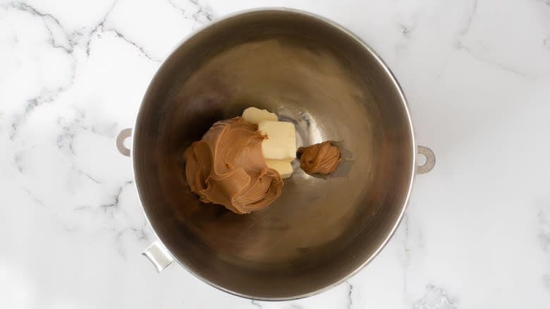 combining peanut butter and butter in bowl