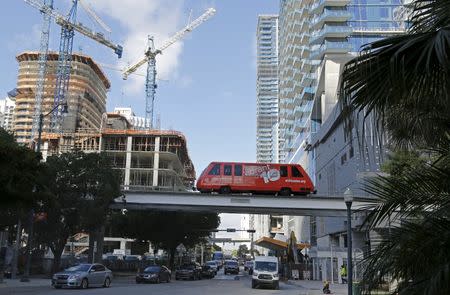 A Peoplemover car is shown with new condominium construction in the background in downtown Miami, Florida November 5, 2015. REUTERS/Joe Skipper