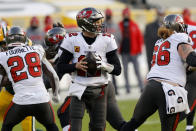 Tampa Bay Buccaneers quarterback Tom Brady (12) looks to pass against the Green Bay Packers during the first half of the NFC championship NFL football game in Green Bay, Wis., Sunday, Jan. 24, 2021. (AP Photo/Jeffrey Phelps)