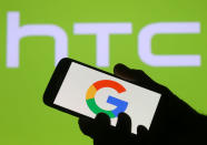 <p>The Google logo is seen on a smartphone in front of a displayed HTC logo in this illustration taken September 21, 2017. REUTERS/Dado Ruvic/Illustration </p>