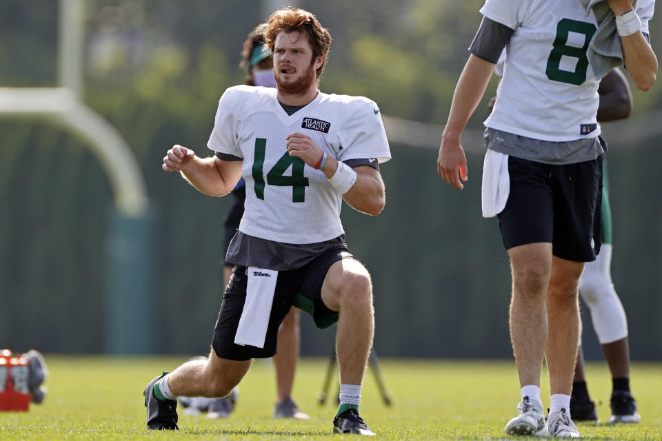 New York Jets quarterback Sam Darnold (14) stretches during a practice at the NFL football team's training camp in Florham Park, N.J., Tuesday, Aug. 25, 2020. (AP Photo/Adam Hunger)