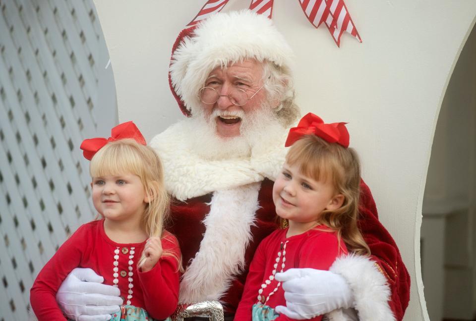 Santa takes a photo with Mary Cole Armstrong, left, and Ellen Clark Armstrong at the Governor's Mansion during the Capital City Lights event in downtown Jackson last year.