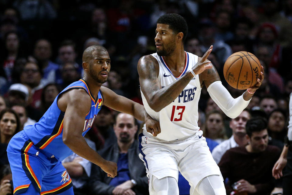 Los Angeles Clippers' Paul George (13) is defended by Oklahoma City Thunder's Chris Paul (3) during the second half of an NBA basketball game, Monday, Nov. 18, 2019, in Los Angeles. The Clippers won 90-88. (AP Photo/Ringo H.W. Chiu)