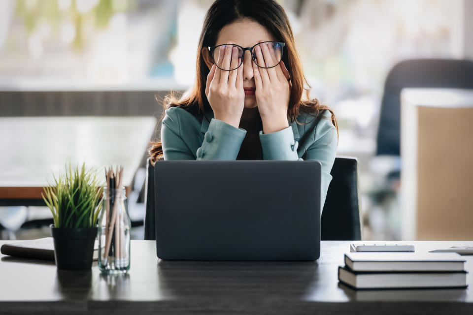 stressed out businesswoman sitting in her office