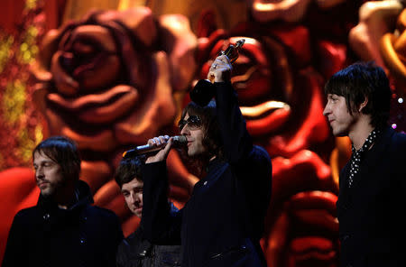 FILE PHOTO: Noel Gallagher (2nd R), Andy Bell (L), Liam Gallagher and Gem Archer (R) of Oasis accept the award for outstanding contribution to music at the Brit Awards at the Earls Court Arena in London February 14, 2007. REUTERS/Kieran Doherty/File Photo