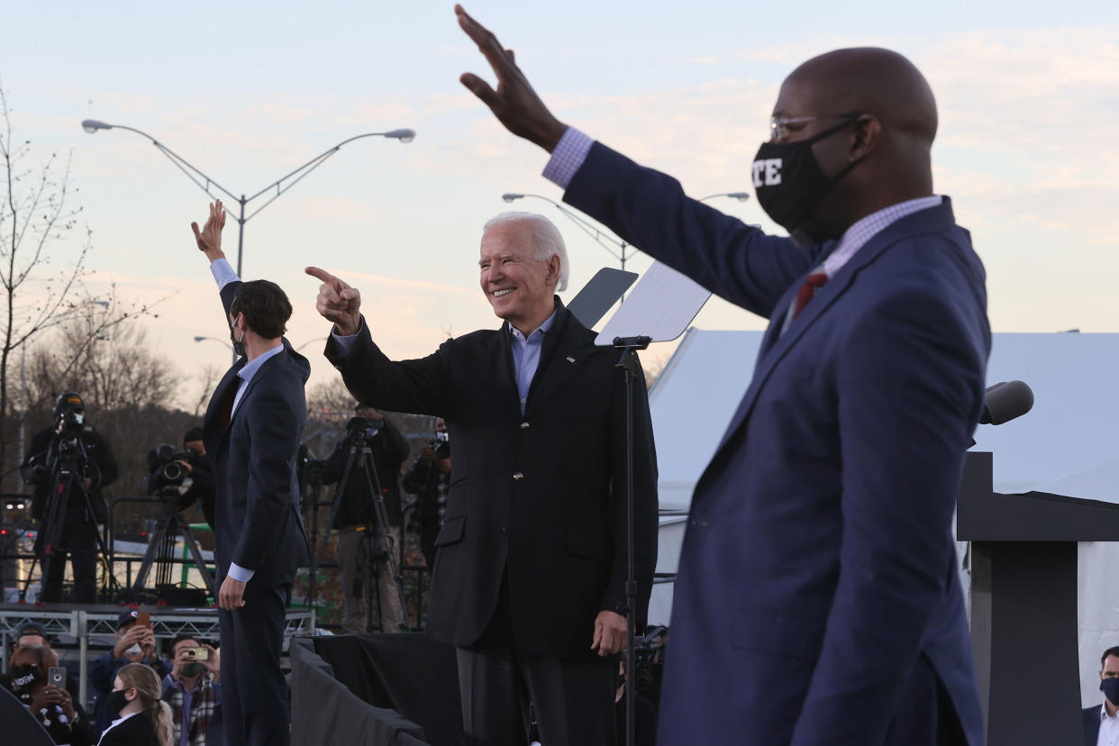 President-elect Joe Biden along with democratic candidates for the Senate Jon Ossoff and Rev. Raphael Warnock greet supporters during a campaign rally the day before their runoff election in Atlanta, on Jan. 04, 2021.