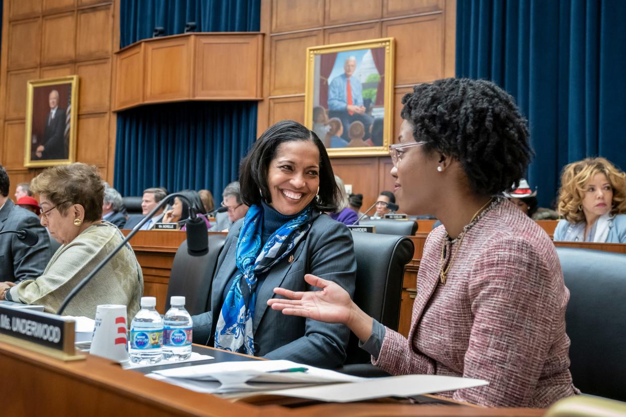 Rep. Jahana Hayes, D-Conn., left, and Rep. Lauren Underwood, D-Ill., talk during a markup in the House Education and Labor Committee on Capitol Hill in Washington, March 6, 2019.