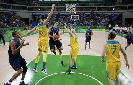 2016 Rio Olympics - Basketball - Preliminary - Men's Preliminary Round Group A Australia v France - Carioca Arena 1 - Rio de Janeiro, Brazil - 06/08/2016. Nando de Colo (FRA) of France drives between Andrew Bogut (AUS) of Australia and Aron Baynes (AUS) of Australia. REUTERS/Jim Young