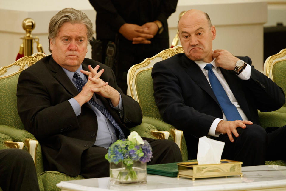 Steve Bannon and Gary Cohn watch a signing ceremony