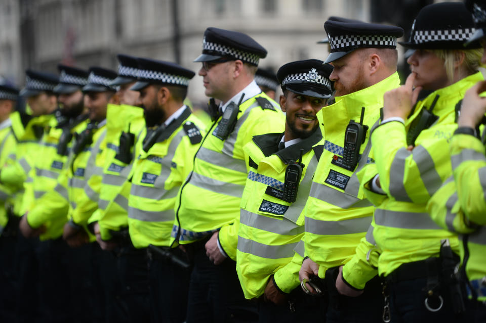 Police watch Extinction Rebellion protesters at their final destination of Parliament Square in Westminster after marching from their camp at Marble Arch. (PA)