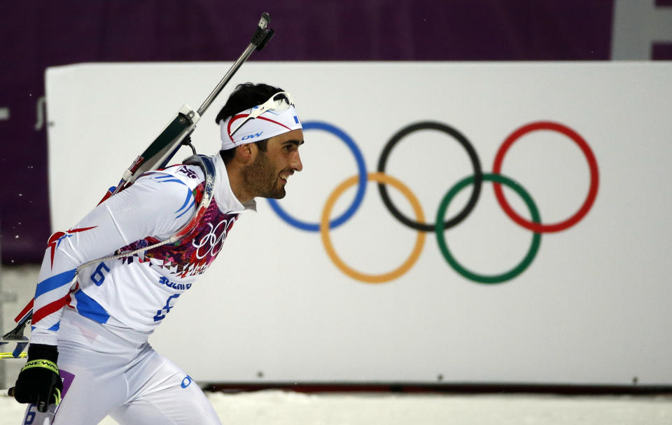 France's Martin Fourcade competes on his way to win the gold medal in the men's biathlon 12.5k pursuit, at the 2014 Winter Olympics, Monday, Feb. 10, 2014, in Krasnaya Polyana, Russia. (AP Photo/Felipe Dana)