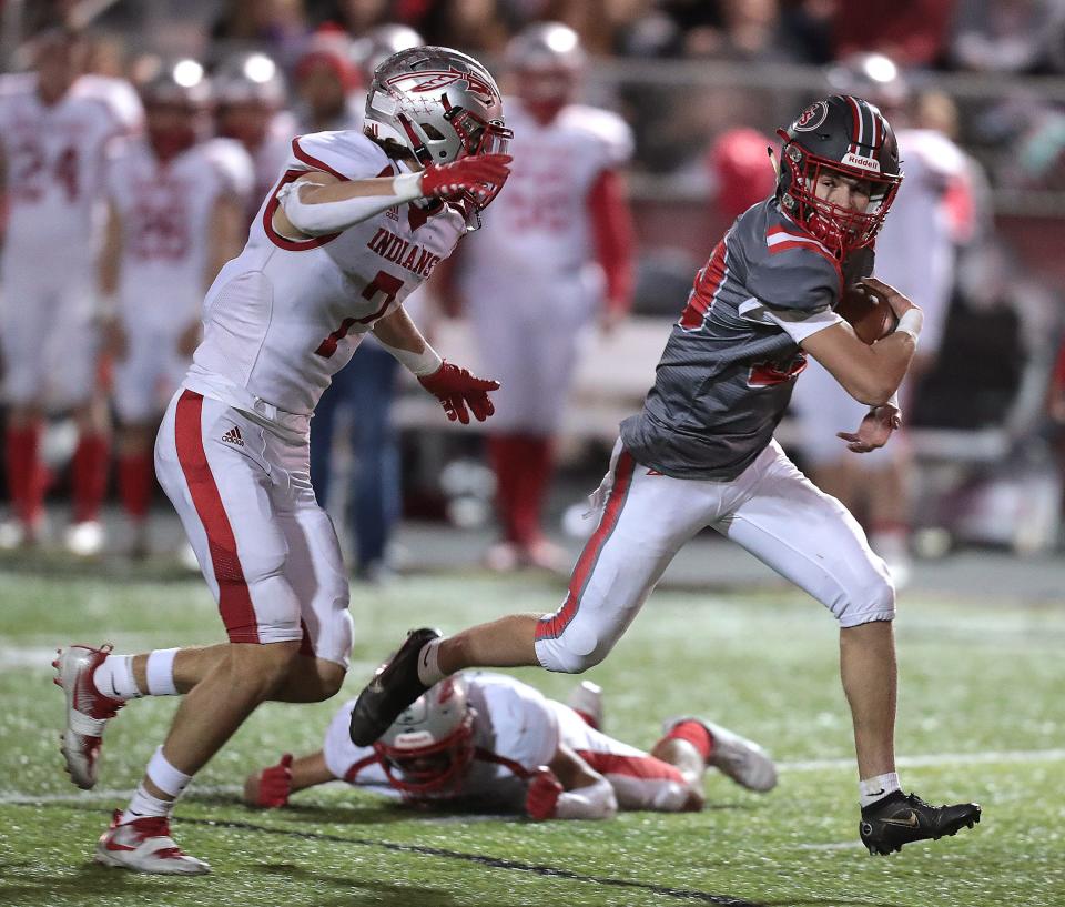 Canton South quarterback Poochie Snyder runs for a second-half gain with pressure from Northwest's Caden Beichler, Friday, Oct. 21, 2022.