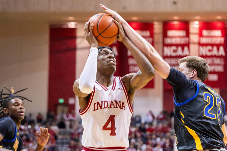 Dec 19, 2023; Bloomington, Indiana, USA; Indiana Hoosiers forward Anthony Walker (4) shoots the ball while Morehead State Eagles guard Riley Minix (22) defends in the first half at Simon Skjodt Assembly Hall.