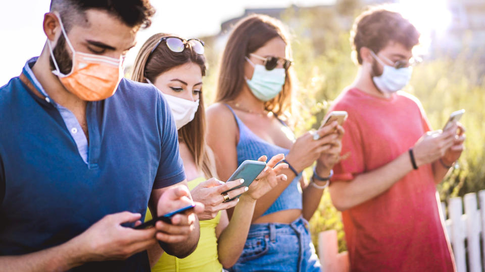 Millennial wearing a face mask safe from Coronavirus, Covid-19. Focus on the blonde woman hands