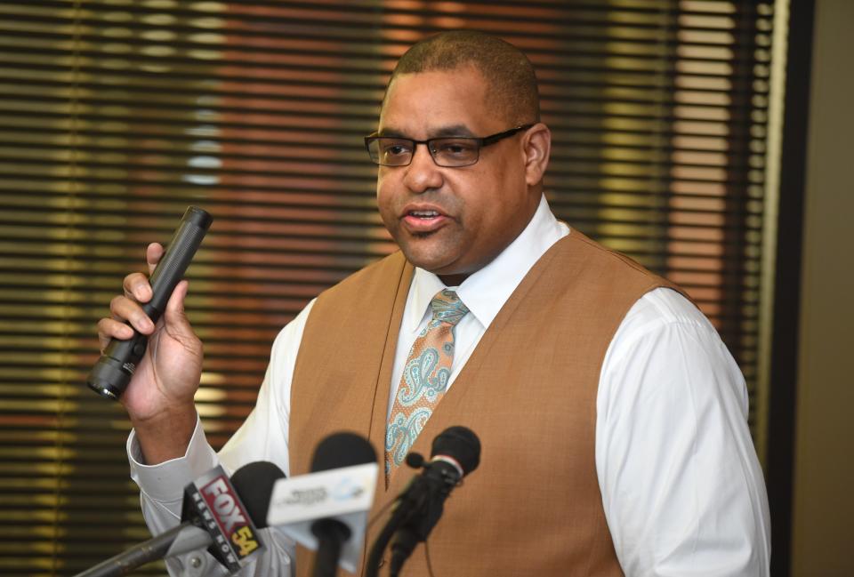 FILE - During a press conference Feb. 11, 2020, at the Richmond County Sheriff's Office, Sheriff Richard Roundtree holds a Stinger flashlight similar to the one that was used as a weapon during an altercation between two deputies at a crime scene. Roundtree, along with former deputy Nicholas Nunes and deputy Brandon Keathley are being sued in civil court for negligence while administering aid to a dying teenager.