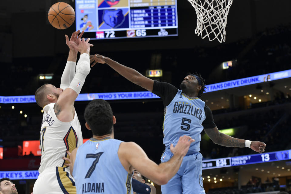 Memphis Grizzlies guard Vince Williams Jr. (5) defends against New Orleans Pelicans center Jonas Valanciunas in the first half of an NBA basketball game, Monday, Feb. 12, 2024, in Memphis, Tenn. (AP Photo/Brandon Dill)