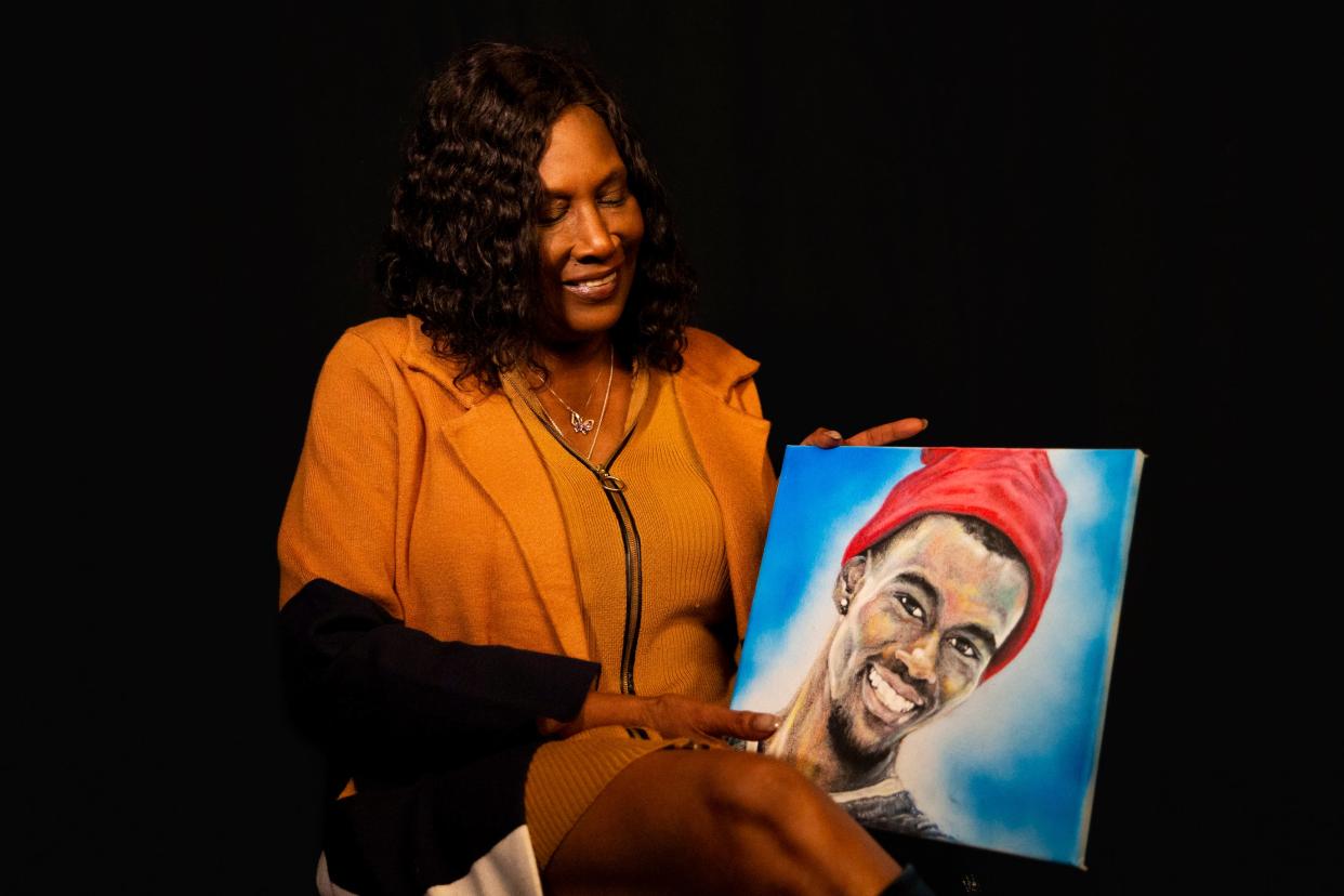 RowVaughn Wells, the mother of Tyre Nichols, smiles at a painting of her son as she poses for a portrait in Memphis, Tenn., on Thursday, January 11, 2024.