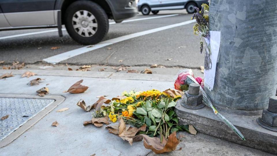 Flowers sit at the corner of Friant Road and Audubon Drive in north Fresno on Jan. 19, 2022, in memory of cyclist and retired teacher Paul Moore who died there a week earlier while crossing the intersection in a recumbent bike.