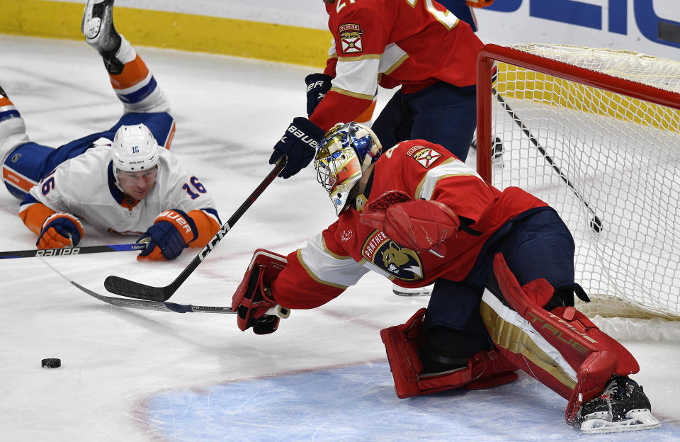 Florida Panthers goaltender Anthony Stolarz (41) stops the puck in front of New York Islanders right wing Julien Gauthier (16) during the first period of an NHL hockey game, Saturday, Dec. 2, 2023, in Sunrise, Fla. (AP Photo/Michael Laughlin)