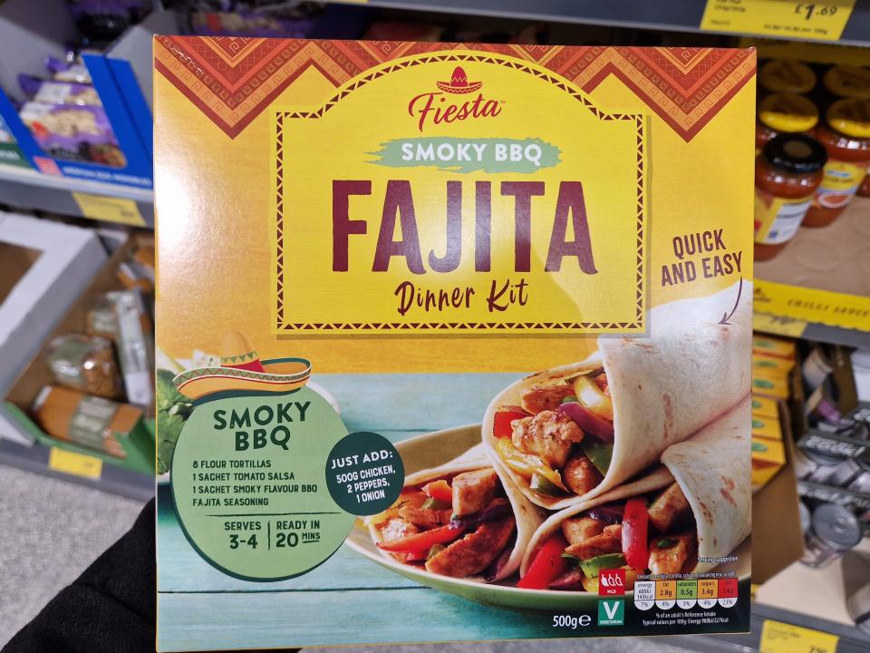 The writer holds a Fiesta smoky BBQ fajita dinner kit