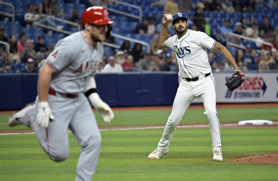 Los Angeles Angels' Brandon Drury, left, races to first base as Tampa Bay Rays' Zach Eflin makes a play on a comebacker to the mound during the fifth inning of a baseball game Monday, April 15, 2024, in St. Petersburg, Fla. (AP Photo/Steve Nesius)