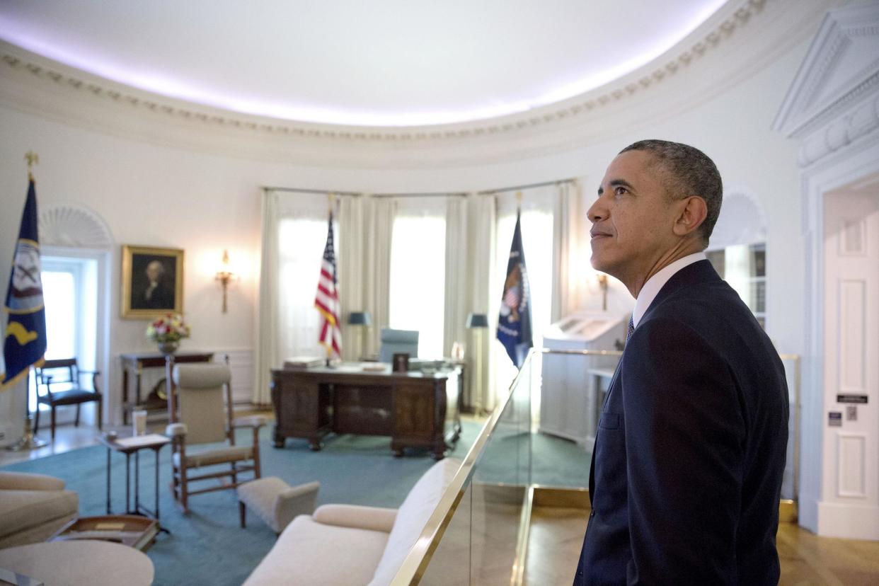 President Barack Obama views a replica of the Oval Office at the Lyndon Baines Johnson Presidential Library in a photo captured by former White House photographer Pete Souza: LBJ Library/Pete Souza