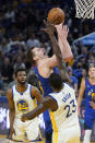 Denver Nuggets center Nikola Jokic, top, shoots over Golden State Warriors forward Draymond Green (23) during the first half of Game 2 of an NBA basketball first-round playoff series in San Francisco, Monday, April 18, 2022. (AP Photo/Jeff Chiu)