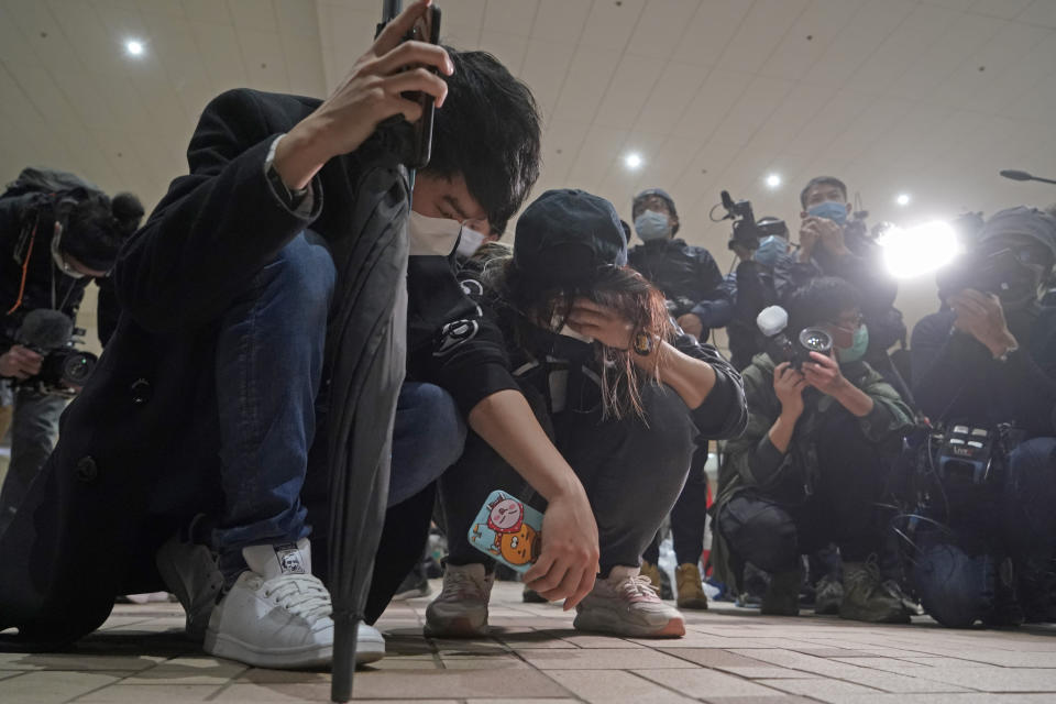 Supporters of one of the 47 pro-democracy activists react outside a court in Hong Kong Thursday, March 4, 2021. A Hong Kong court on Thursday remanded all 47 pro-democracy activists charged under a Beijing-imposed national security law in custody, ending a four-day marathon court hearing. (AP Photo/Kin Cheung)